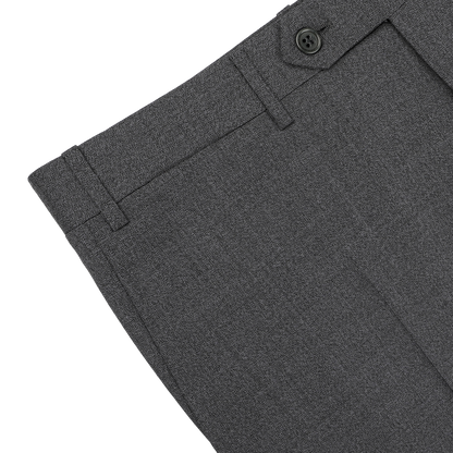 Close-up of the upper section of Canali's Grey Melange Wool Flat Front Trousers, featuring a button and belt loops, displayed on a white surface.