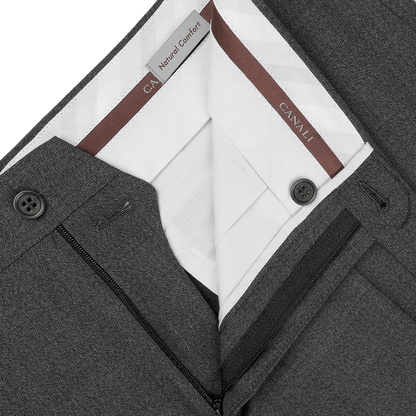 Close-up of Canali's Grey Melange Wool Flat Front Trousers, showcasing black buttons and a visible white inner lining labeled "Natural Comfort.