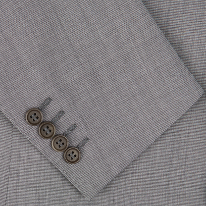 Four brown buttons on the sleeve of a Canali Light Grey Micro Check Wool Suit embody classic sartorial elegance.