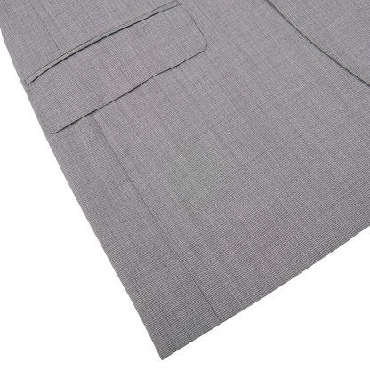 Close-up of a gray fabric with a herringbone pattern, possibly a part of a Canali Light Grey Micro Check Wool Suit embodying classic sartorial elegance.