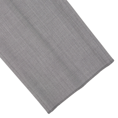 Gray fabric with a herringbone pattern laid flat on a white surface, embodying classic sartorial elegance- Canali Light Grey Micro Check Wool Suit.