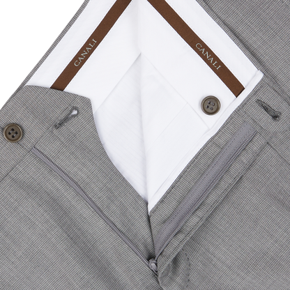 Close-up of a light grey micro check wool suit layered over a white shirt with Canali brand on the collar, showcasing classic sartorial elegance.
