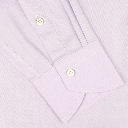 Close-up of a Canali Lilac Cotton Herringbone Single Cuff Shirt cuff, featuring two white buttons and a subtly sophisticated pattern.