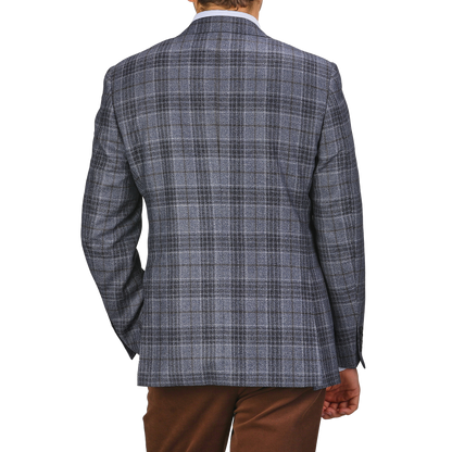 A person, embodying classic Milanese style, is shown from the back in a Canali Mid Blue Checked Wool Silk Drop 6 Blazer against a plain background.