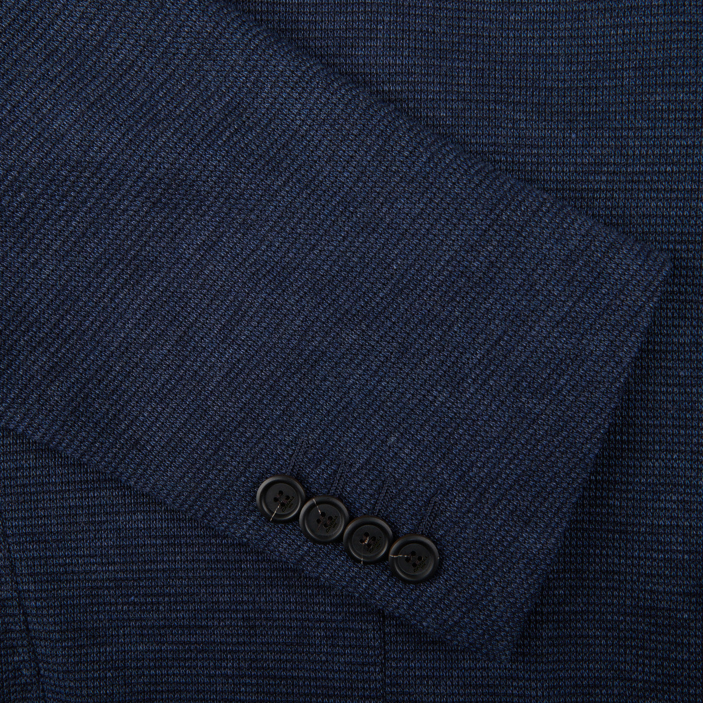A close up of a Canali Navy Blue Melange Wool Jersey Jacket with buttons in casual tailoring.