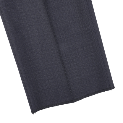 Close-up of a navy blue fabric swatch with a micro design pattern against a white background, capturing the essence of Canali's classic sartorial elegance in their Navy Blue Micro Design Wool Suit.