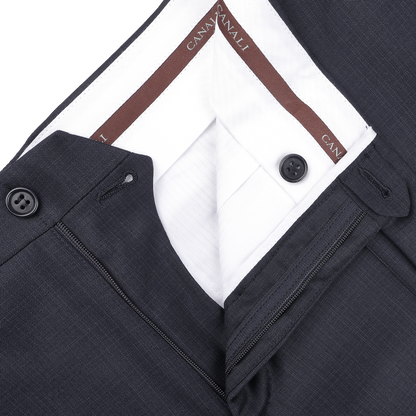 Close-up of navy blue formal suit trousers with micro design, featuring classic sartorial elegance and a brown waistband labeled "Canali".