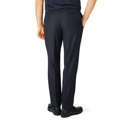 The man is wearing navy blue wool twill Canali formal trousers.