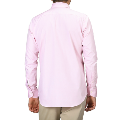 A person dressed in a Pink Cotton Single Cuff Shirt by Canali and beige pants is shown from the back against a white background.