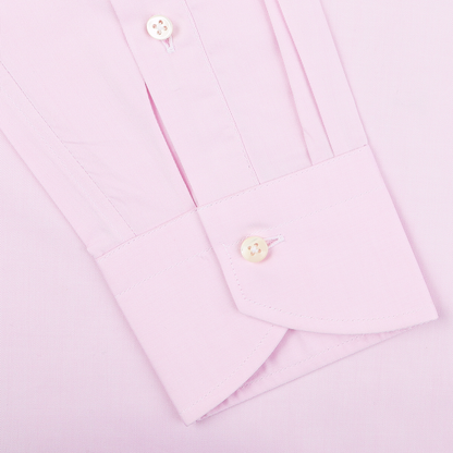Close-up of a Canali Pink Cotton Single Cuff Shirt sleeve, showcasing a buttoned cuff that epitomizes the elegance of this formal shirt.
