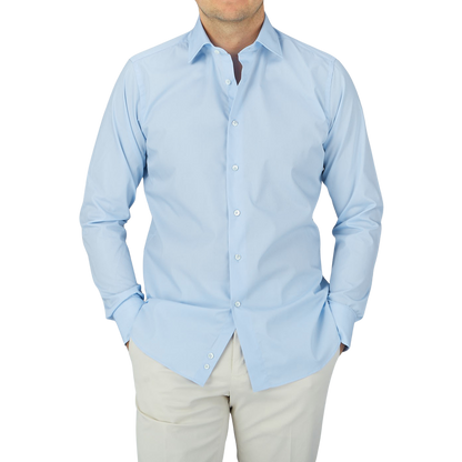 A man wearing a Canali Plain Blue Cotton Poplin Single Cuff Shirt.