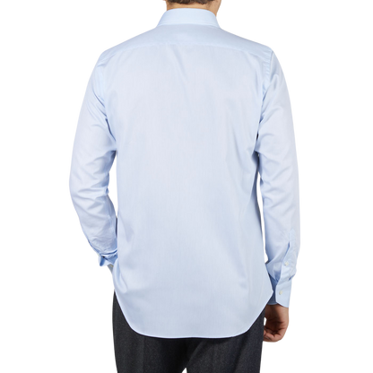 The back view of a man wearing a Canali Sky Blue Cotton Single Cuff Shirt.