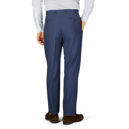 A person wearing Slate Blue Semi-Plain Wool Flat Front Canali trousers and brown shoes.