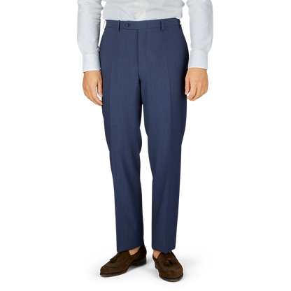 Man standing in navy Canali Slate Blue Semi-Plain Wool Flat Front Trousers paired with brown shoes.