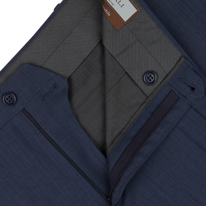 Close-up of a navy blue men's Canali suit jacket with detailed inner lining and Slate Blue Semi-Plain Wool Flat Front Trousers.