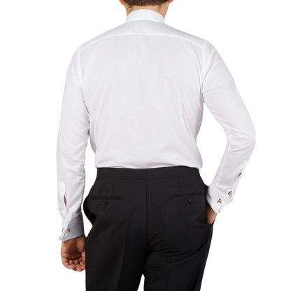 The back view of a man wearing the Canali White Cotton Double Cuff Pleated Dress Shirt.
