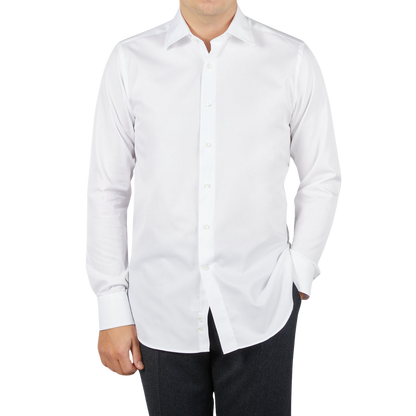 A man wearing a Canali white cotton single cuff shirt made from ultra-soft cotton.