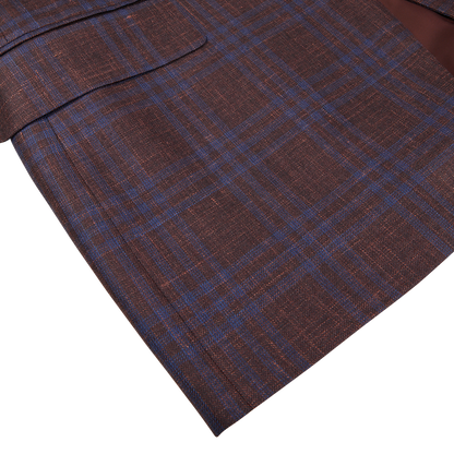 Close-up of a Canali wine red checked wool silk linen blazer with a visible pocket, displayed on a white surface.