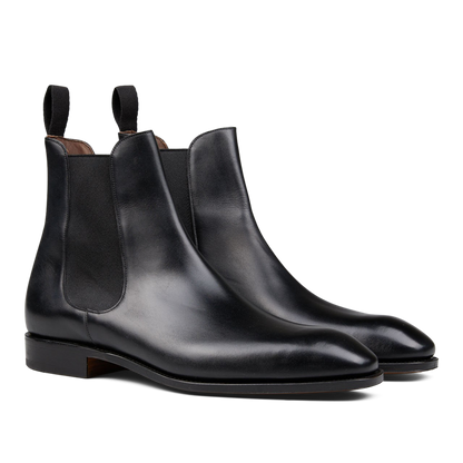 A pair of Carmina Black Calf Leather Simpson Chelsea Boots with elastic side panels, crafted by skilled craftsmen.
