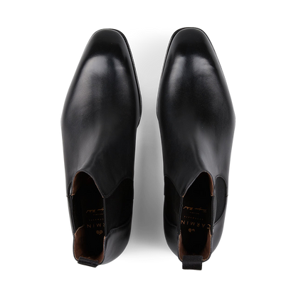 A pair of Carmina's Black Calf Leather Simpson Chelsea Boots displayed against a white background, crafted on the Simpson last.