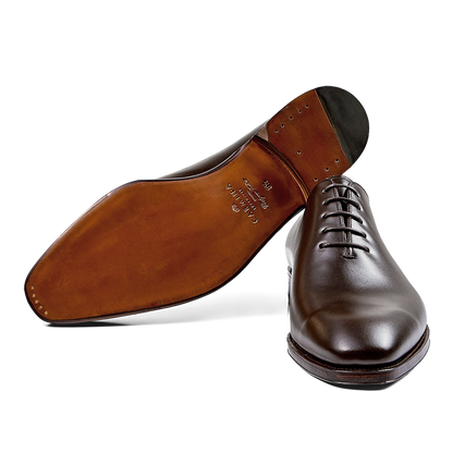 A single Carmina brown calf leather Rain wholecut oxford dress shoe with laces, viewed from a side angle.