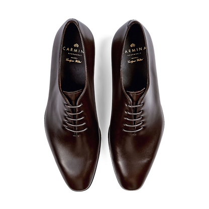 A pair of polished Carmina Brown Calf Leather Rain Wholecut Oxfords.