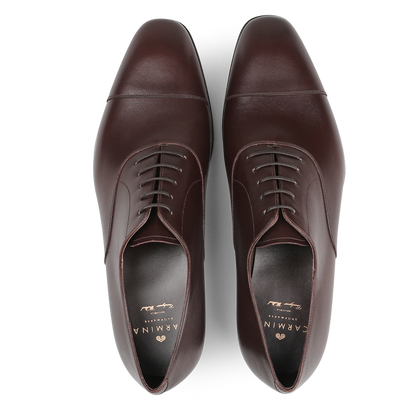 A pair of adaptable Carmina Brown Calf Rain Captoe Oxford Shoes with closed lacing, crafted on the Rain last, displayed from above on a plain background.