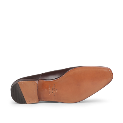 Bottom view of the Brown Calf Rain Captoe Rain Oxford Shoes from Carmina, featuring a tan leather sole and a rubber heel piece, highlighting the versatile design style reminiscent of Charles Goodyear's innovation.