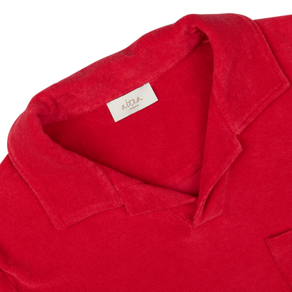 Close-up of an Altea coral red cotton towelling capri collar polo shirt label and collar.