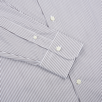 A close-up of the Alessandro Gherardi Brown Stripe Cotton Single Cuff Shirt, featuring thin brown stripes on white cotton. The angled sleeve highlights the single cuff and white buttons running down the front. , available at Richard Gelding Mayfair