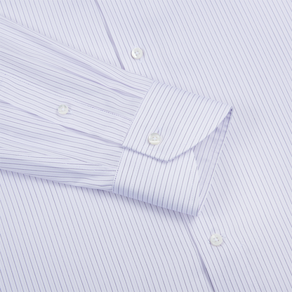 A close-up of the Canali Pink/Blue Stripe Cotton Shirt sleeve shows the cuff fastened with a white button; the neatly pressed shirt features fine vertical stripes and two extra white buttons on the body. , available at Richard Gelding Mayfair