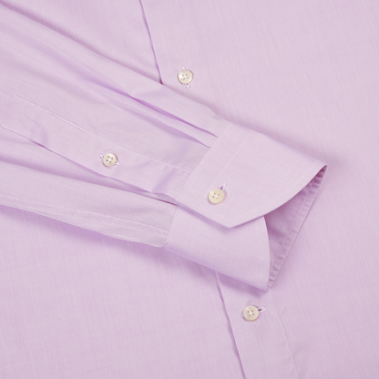 A close-up of the Canali Pink Textured Cotton Regular Fit Shirt shows the sleeve, cuff, and part of the body with white buttons. The finely textured fabric and unbuttoned cuff are neatly folded against the shirt. , available at Richard Gelding Mayfair