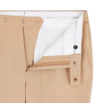 A close-up of Germano Beige Soft Touch Tencel Formal Trouser with open waistband and fly, tan zipper, metal clasp, inner button, and white lining. The label inside reads MADE IN ITALY and partially shows the brand name. , available at Richard Gelding Mayfair
