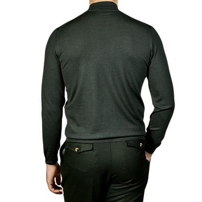 The back view of a man wearing a Fedeli Green 140s Wool Mockneck Sweater.