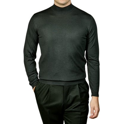 A man wearing a Green 140s Wool Mockneck Sweater made by Fedeli.