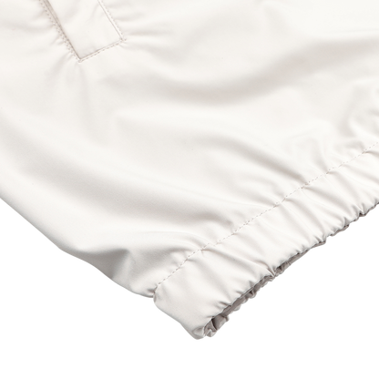 Close-up of the Beige Nougat Nylon Reversible Blouson Jacket by Fedeli, showcasing its water-resistant nylon sleeve with an elastic cuff and stitching detail on a white surface.