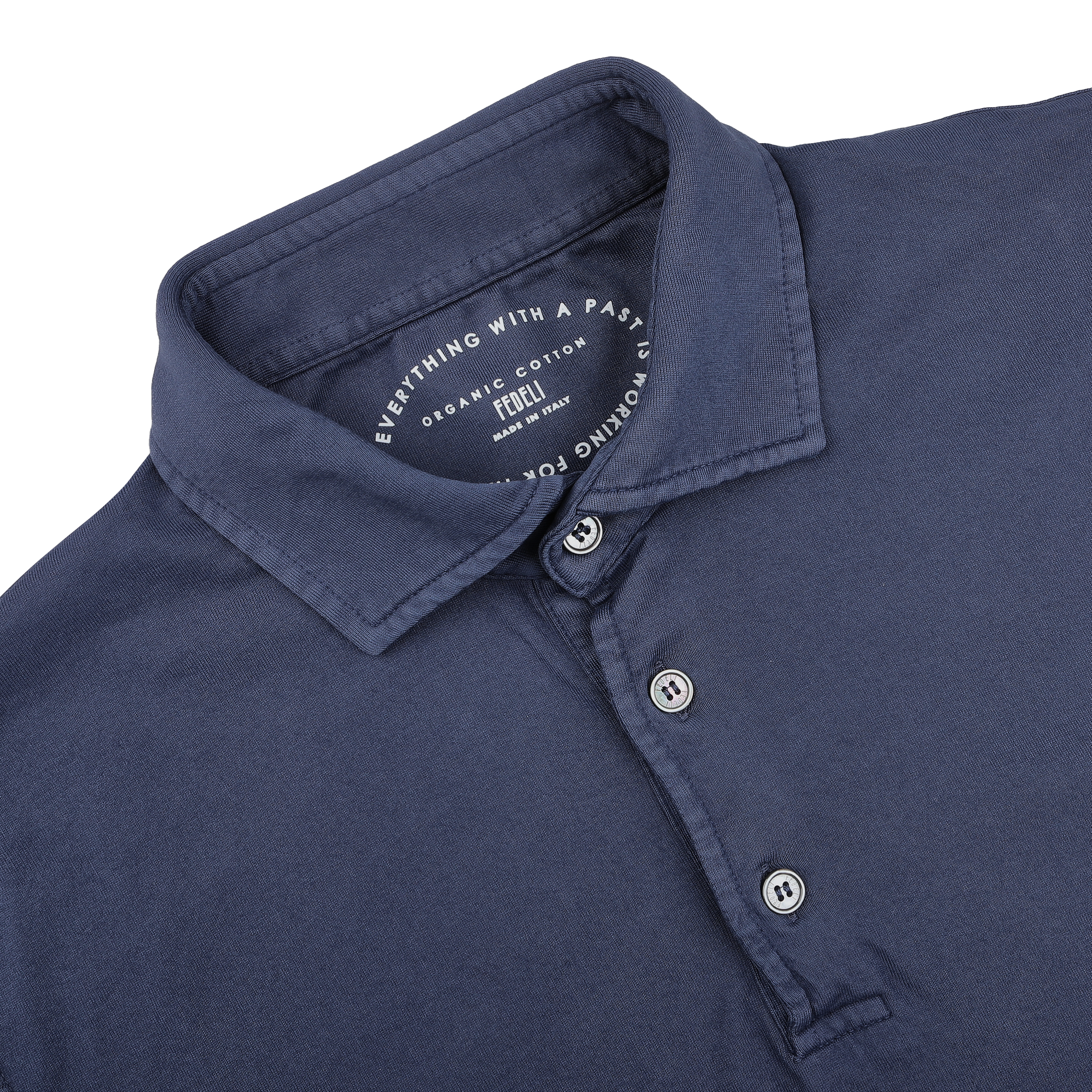 The Fedeli Dark Blue Organic Cotton LS Polo Shirt offers luxurious casual-wear with timeless elegance, featuring a three-button collar and the text "Everything with a past, nothing forgotten.