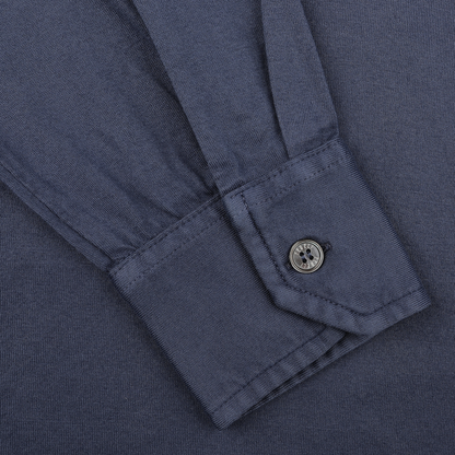 Close-up of a Dark Blue Organic Cotton LS Polo Shirt by Fedeli, highlighting the long-sleeved cuff with a single button.