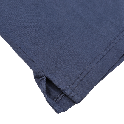 A close-up of a Dark Blue Organic Cotton LS Polo Shirt by Fedeli shows detailed stitching and a small side slit, crafted from luxurious organic Giza cotton.