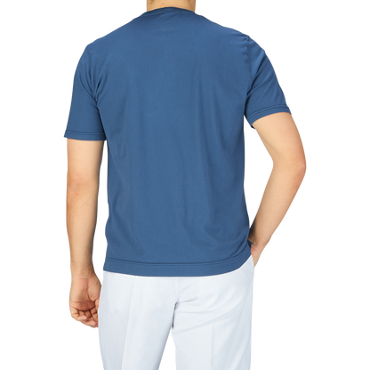 The back view of a man wearing a Fedeli Indigo Blue Organic Cotton T-Shirt.
