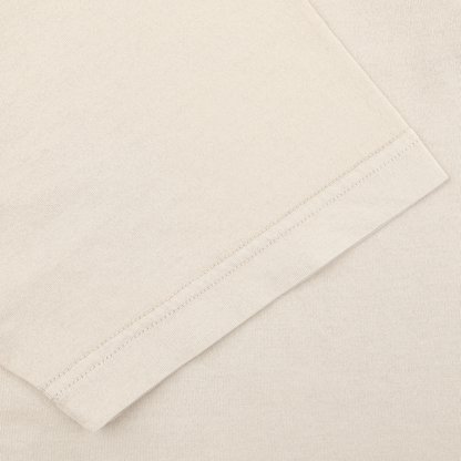 Close-up of the sleeve and shoulder seam of a luxurious casual-wear polo shirt by Fedeli, in light beige, featuring organic cotton and a Capri collar.
