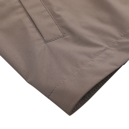 Close-up of Light Brown Nylon Rainproof Field Jacket by Fedeli, featuring a pocket and visible stitching.