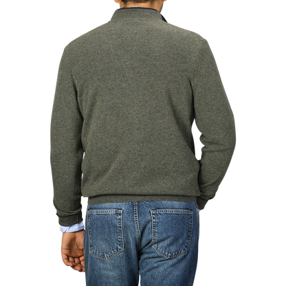 A person is shown from behind, wearing a Moss Green Wool Cashmere 1/4 Zip Sweater by Fedeli and blue jeans.