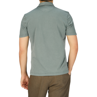 The back view of a man wearing a Fedeli Olive Green Organic Cotton Polo Shirt.