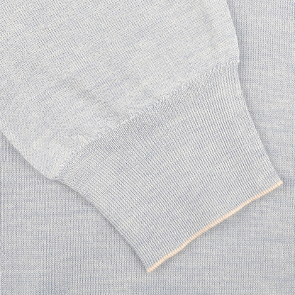 Close-up of a sky blue knit sleeve with ribbed cuff on the Fedeli Sky Blue Cashmere Silk 1/4 Zip Sweater, crafted from an exquisite cashmere-silk blend.