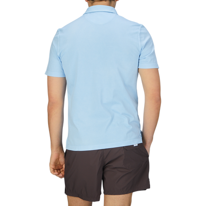 The back view of a man wearing a luxury Sky Blue Organic Cotton Polo Shirt by Fedeli.