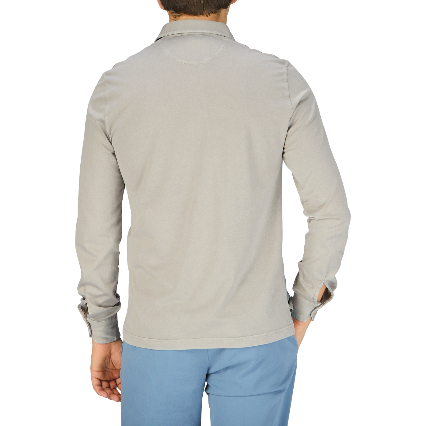 The back view of a man wearing a Fedeli Taupe Beige Organic Cotton LS Polo Shirt and blue pants.