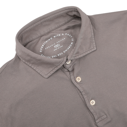 The Fedeli Taupe Beige Organic Cotton LS Polo Shirt is a luxury item with a collar and three buttons, crafted from organic Giza cotton. The inner label reads: "Everything with a past is organic cotton. Recycled for the future.