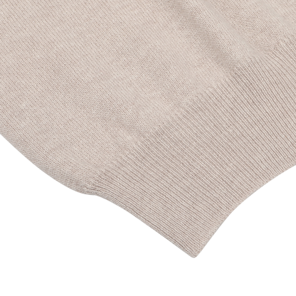 Close-up of the Fedeli Taupe Beige Wool Cashmere 1/4 Zip Sweater, showcasing a horizontal seam with ribbed texture at the edge, highlighting its luxurious material blend.