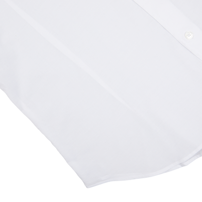 A partial view of a Fedeli white cotton stretch beach shirt against a light background.